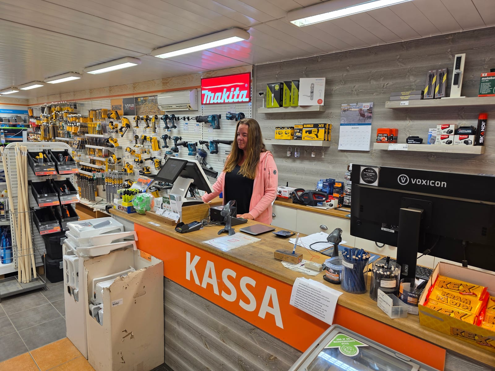 Medarbetare bakom kassadisken i GRG Svenssons byggvaruhus i Grundsund